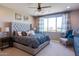 Beautiful bedroom featuring a tufted headboard, soft lighting, and a serene color palette at 1940 W Kinfield Trl, Phoenix, AZ 85085