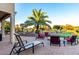 Serene backyard with a fire pit, outdoor seating, and lush landscaping, perfect for outdoor enjoyment at 20151 N Riverbank Rd, Maricopa, AZ 85138