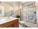 Cozy bathroom with a shower-tub combo and a spacious vanity with a sink at 20151 N Riverbank Rd, Maricopa, AZ 85138