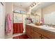 Bathroom featuring double sinks, wood cabinets, and a glass-enclosed shower at 20151 N Riverbank Rd, Maricopa, AZ 85138