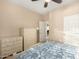 Bedroom featuring neutral walls, a ceiling fan, and a comfortable bed with blue paisley bedding at 20151 N Riverbank Rd, Maricopa, AZ 85138