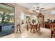 Dining area with tile flooring, a ceiling fan, and natural light from surrounding windows at 20151 N Riverbank Rd, Maricopa, AZ 85138