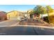 Charming single-story home featuring a two-car garage, desert landscaping, and a cozy front patio at 20151 N Riverbank Rd, Maricopa, AZ 85138