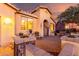 Cozy front patio featuring desert landscaping, a seating area, and a charming entryway at 20151 N Riverbank Rd, Maricopa, AZ 85138