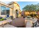 Cozy front patio featuring desert landscaping, a seating area, and a charming entryway at 20151 N Riverbank Rd, Maricopa, AZ 85138