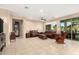 Spacious living room with tile floors, a ceiling fan, and large sliding glass doors to the backyard at 20151 N Riverbank Rd, Maricopa, AZ 85138