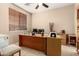 Home office featuring wood desk, tile flooring, and neutral colored walls at 20151 N Riverbank Rd, Maricopa, AZ 85138