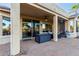 Covered patio featuring sturdy pillars, fan, sliding doors, and a welcoming seating area at 20151 N Riverbank Rd, Maricopa, AZ 85138