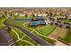 Aerial view of tennis and pickle ball courts surrounded by lush landscaping in a desirable community at 20151 N Riverbank Rd, Maricopa, AZ 85138