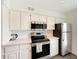 Bright kitchen featuring stainless steel appliances, white subway tile backsplash and white cabinets at 2025 E Campbell Ave # 227, Phoenix, AZ 85016