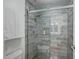 Modern tiled shower with sliding glass door, niche, and sleek shower head at 2025 E Campbell Ave # 227, Phoenix, AZ 85016