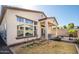 View of the home's backyard with a covered patio, bbq and a block wall fence for privacy at 21150 W Minnezona Ave, Buckeye, AZ 85396