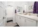 Bright bathroom featuring double sinks, vanity, and a shower-tub combination at 21150 W Minnezona Ave, Buckeye, AZ 85396