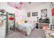 Whimsical bedroom with colorful decor, plush toys, and personal touches, creating a fun and inviting space at 21150 W Minnezona Ave, Buckeye, AZ 85396