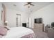 Bedroom featuring a large bed, dresser, ceiling fan, and an ensuite bathroom with a view at 21150 W Minnezona Ave, Buckeye, AZ 85396