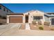 Inviting home with a brown garage door and a charming awning over the front window, creating a warm and welcoming entrance at 21150 W Minnezona Ave, Buckeye, AZ 85396