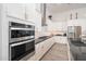 Modern kitchen featuring white cabinets, stainless steel appliances, dark countertops, and subway tile backsplash at 21150 W Minnezona Ave, Buckeye, AZ 85396