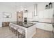 Modern kitchen featuring white cabinets, stainless steel appliances, dark countertops, and large island with barstool seating at 21150 W Minnezona Ave, Buckeye, AZ 85396