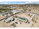 Aerial view of a home with solar panels, outbuildings and a metal roof and a storage unit nearby at 21621 W Narramore Rd, Buckeye, AZ 85326