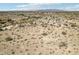 Expansive aerial view showcasing the desert landscape and surrounding homes in a rural community at 21621 W Narramore Rd, Buckeye, AZ 85326