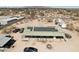 Close aerial view of desert home with solar panels, car, truck and RV parking on property at 21621 W Narramore Rd, Buckeye, AZ 85326