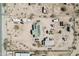 Aerial view of the home's metal roof and land with RVs and other vehicles with surrounding buildings at 21621 W Narramore Rd, Buckeye, AZ 85326