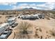 Aerial view of a desert home with recreational vehicles and mountain views at 21621 W Narramore Rd, Buckeye, AZ 85326