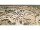 Wide aerial shot of desert landscape and rural homes, with visible properties and road access nearby at 21621 W Narramore Rd, Buckeye, AZ 85326