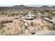 Aerial view of rural property with home, outbuildings, RVs, fencing, and desert landscape at 21621 W Narramore Rd, Buckeye, AZ 85326