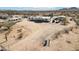 A desert landscape with a home featuring a collection of vehicles and RVs at 21621 W Narramore Rd, Buckeye, AZ 85326