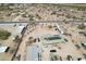 Aerial view of the house with metal buildings, a car, and solar panels on the metal roof at 21621 W Narramore Rd, Buckeye, AZ 85326