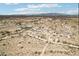 Wide aerial shot showing the desert landscape and rural homes with roads and mountains in the background at 21621 W Narramore Rd, Buckeye, AZ 85326