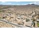 Wide aerial view of desert community with homes, RVs, and mountain views at 21621 W Narramore Rd, Buckeye, AZ 85326