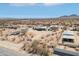 Scenic aerial view of a desert home nestled in the arid landscape with mountains at 21621 W Narramore Rd, Buckeye, AZ 85326