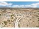 Scenic aerial of the desert landscape featuring mountain views, desert brush and scattered homes in the distance at 21621 W Narramore Rd, Buckeye, AZ 85326