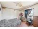 Simple bedroom with neutral walls, a ceiling fan, and natural light from the window at 21621 W Narramore Rd, Buckeye, AZ 85326