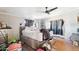 Cluttered bedroom featuring gray walls, a ceiling fan, and an unmade bed at 21621 W Narramore Rd, Buckeye, AZ 85326