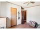 Cozy bedroom with a ceiling fan, wood-look floors and a doorway to another room at 21621 W Narramore Rd, Buckeye, AZ 85326