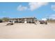 The exterior of a home featuring an open porch and a large, dirt front yard at 21621 W Narramore Rd, Buckeye, AZ 85326