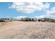 One-story house with a porch and an unpaved yard with cars parked outside at 21621 W Narramore Rd, Buckeye, AZ 85326