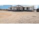 White single-story home featuring a covered porch and a large front yard at 21621 W Narramore Rd, Buckeye, AZ 85326