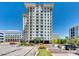 Elegant high-rise apartment building with well-maintained landscaping and a welcoming entrance at 2211 E Camelback Rd # 601, Phoenix, AZ 85016