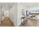 Hallway featuring hardwood floors, white walls, and an open view to the living room at 2211 E Camelback Rd # 601, Phoenix, AZ 85016