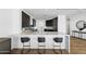 Modern kitchen featuring a marble countertop bar, sleek dark cabinetry, and stylish bar stools at 2211 E Camelback Rd # 601, Phoenix, AZ 85016