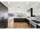 Contemporary kitchen with stainless steel oven, marble countertops and backsplash, and an open view into the living area at 2211 E Camelback Rd # 601, Phoenix, AZ 85016