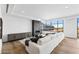 Bright living room featuring a linear fireplace, hardwood floors and expansive windows with cityscape views at 2211 E Camelback Rd # 601, Phoenix, AZ 85016