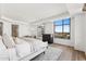 Comfortable main bedroom showcasing a large window with city views, hardwood flooring, and neutral colors at 2211 E Camelback Rd # 601, Phoenix, AZ 85016