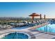 Inviting rooftop pool and spa area, complete with lounge chairs and umbrellas with city views at 2211 E Camelback Rd # 601, Phoenix, AZ 85016