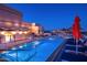 Luxury rooftop pool and lounge area, offering scenic city and mountain views, umbrellas, and lounge chairs at 2211 E Camelback Rd # 601, Phoenix, AZ 85016