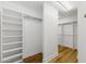 Walk-in closet with custom shelving and hardwood floors at 2211 E Camelback Rd # 601, Phoenix, AZ 85016